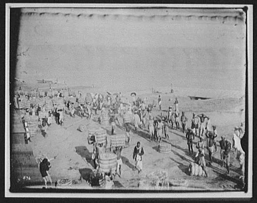 Coolies transferring bales of jute from boats at Saraghat (?), Bangladesh, India, Ganges River, 1895