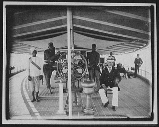 Captain, pilot and wheelman posed on deck of Brahmaputra river steamer, Brahmaputra River, India, 1895