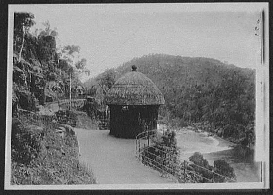 Thatched hut at roadside overlook above river gorge, Tasmania, 1895