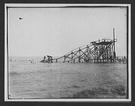 Bathers at large ocean water slide, New Zealand, 1895