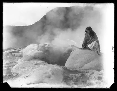 Bella, a Maori guide, sitting at edge of Rotorua geysers, Rotorua, New Zealand, 1895