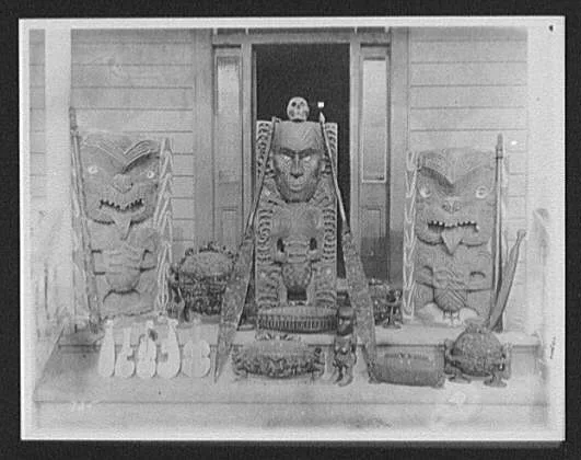 Maori wood carvings, including large and small idols and canoe paddles, New Zealand, 1895