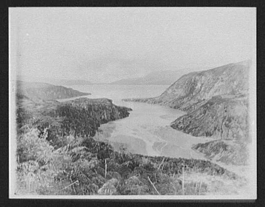 View of inlet and Lake Tarawera surrounded by rocky cliffs, New Zealand, 1895