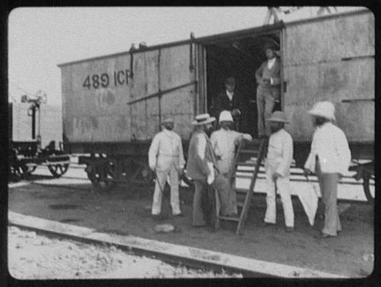 Seven men at door of freight car, India, 1895