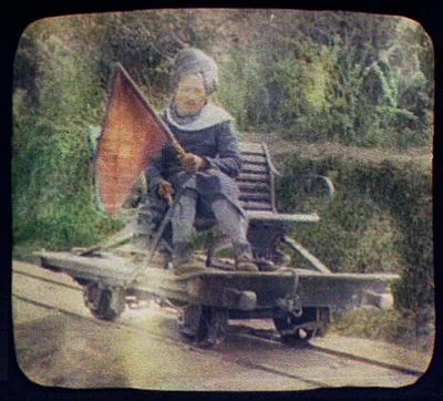 Turbanned man on railway hand car holding red flag, Pakistan, 1895