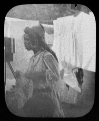 Woman with laundry hanging on clothesline, India, 1895