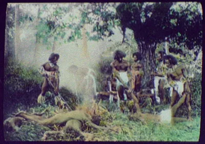 Seven warriors standing over 4 dead (?) bodies, Oceania, 1895