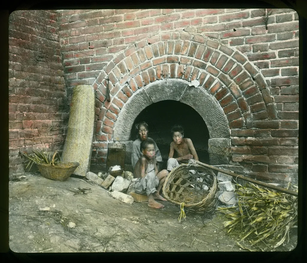 Family living in an arch under the Great Wall, China, 1895