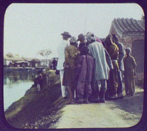 Men and boys standing by river bank, China, 1895