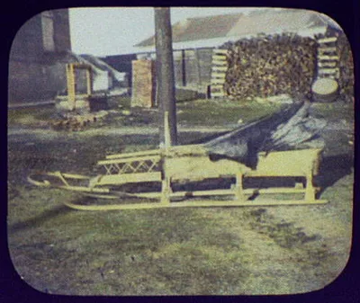 Siberian sledge; full side view with well and large woodpile in…, 1895